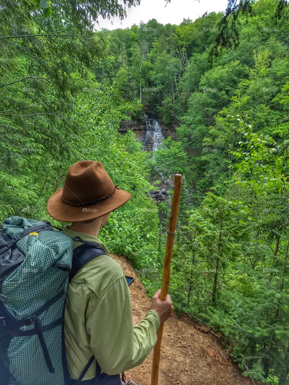 Hiker overlooking waterfall