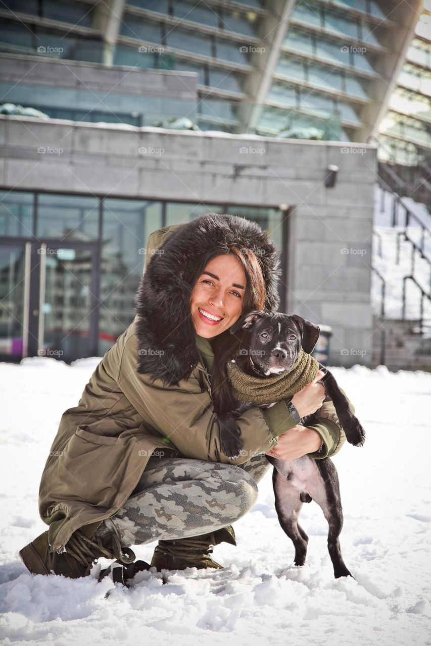 walking the dog down the street, the owner walks the weakling, teaches her, cleans up after her, educates, plays with his pet. people and dogs are best friends