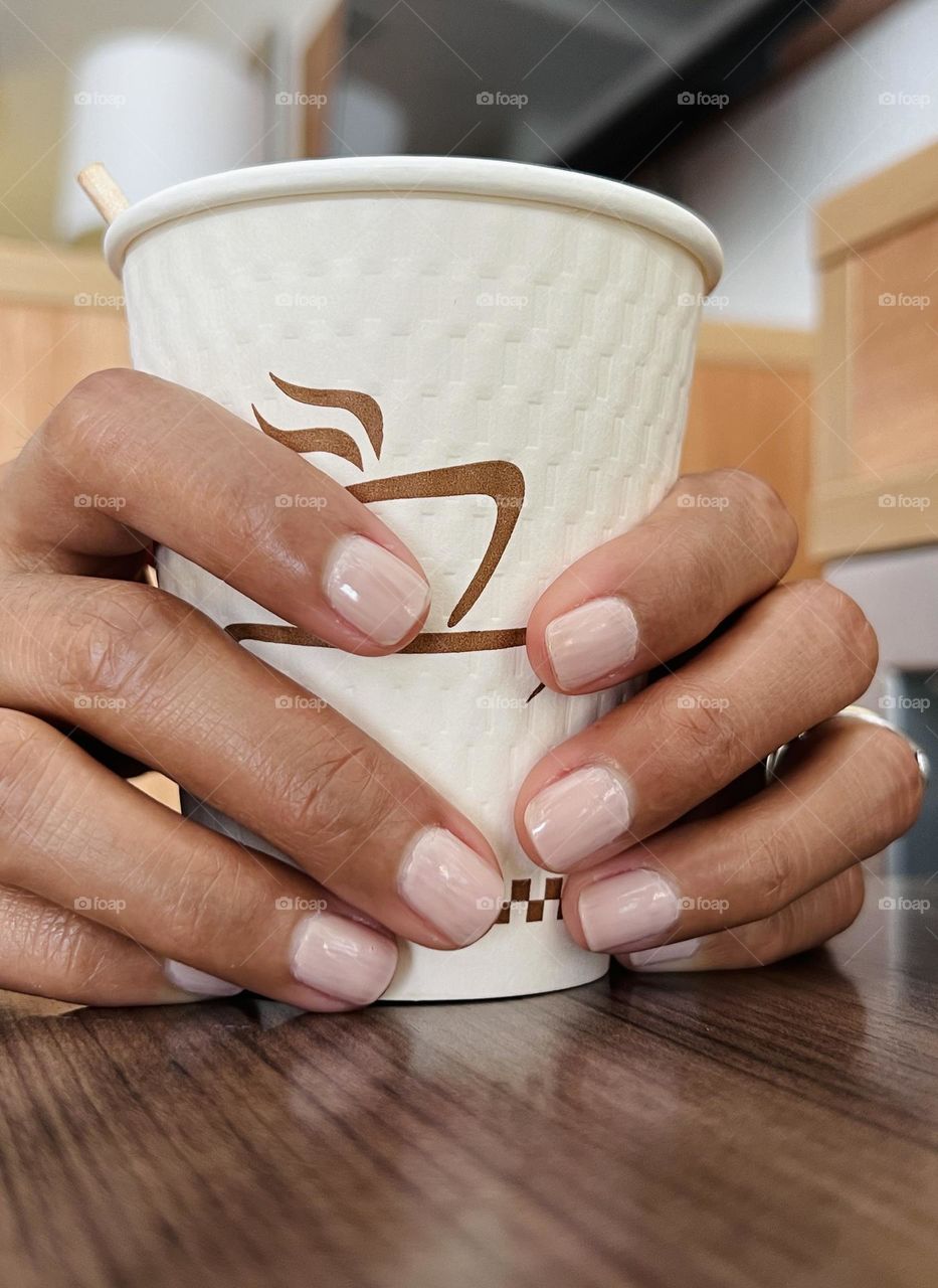 Holding a cup of coffee with painted nails