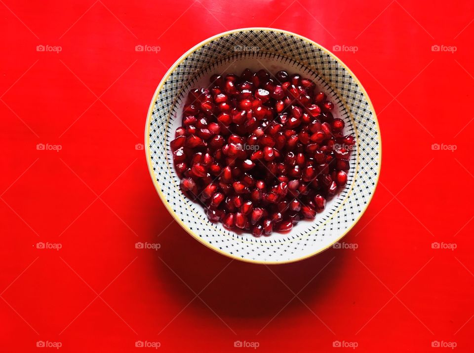 red pomegranate seeds healthy fruits on bowl white background 