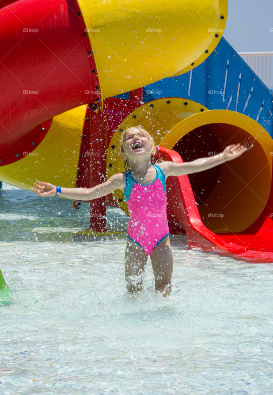 Young Swedish girl 4 years old playing in the waterland/pool on vaccation on Cyprus.