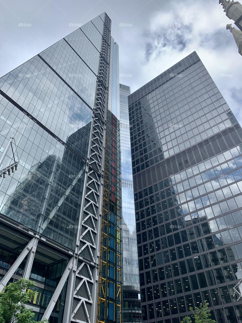 Low angle view of London modern geometric skyscrapers building, business quarter, grey color palette 