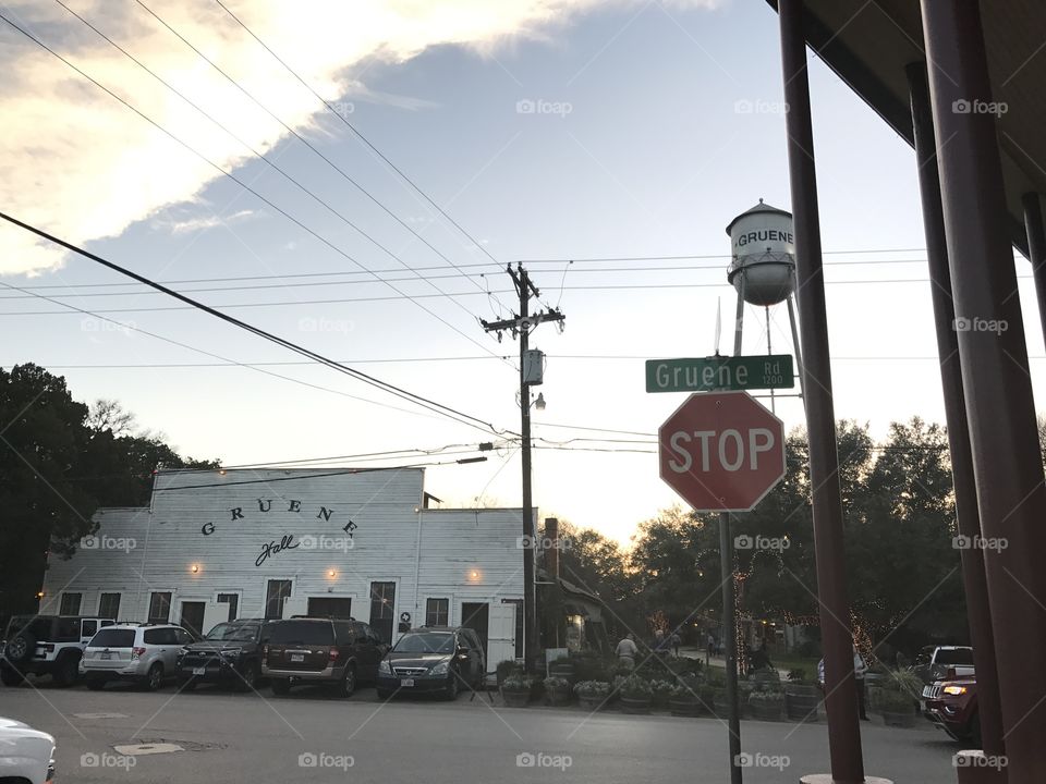 Portrait of Gruene Hall in the foreground and the town's water tower in the background located near New Braunfels, TX. Originally built in the 1800's, Gruene Hall has the distinction of being the oldest, continuously running dance hall in the state of Texas. 