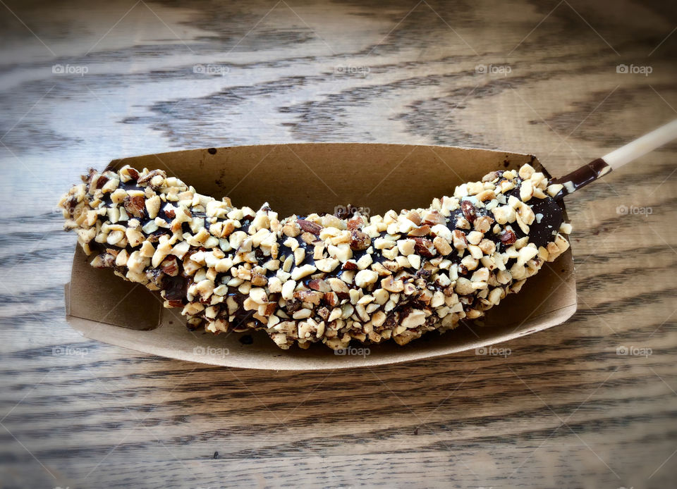 Frozen Banana in chocolate with nuts