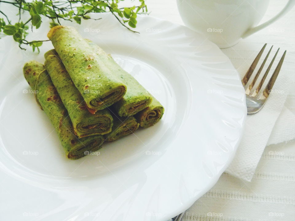 Green pancakes. Green pancakes on white plate