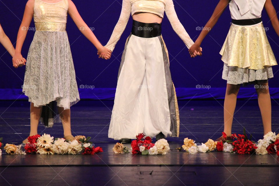 Dance the night away. Dance recital performers holding hands 