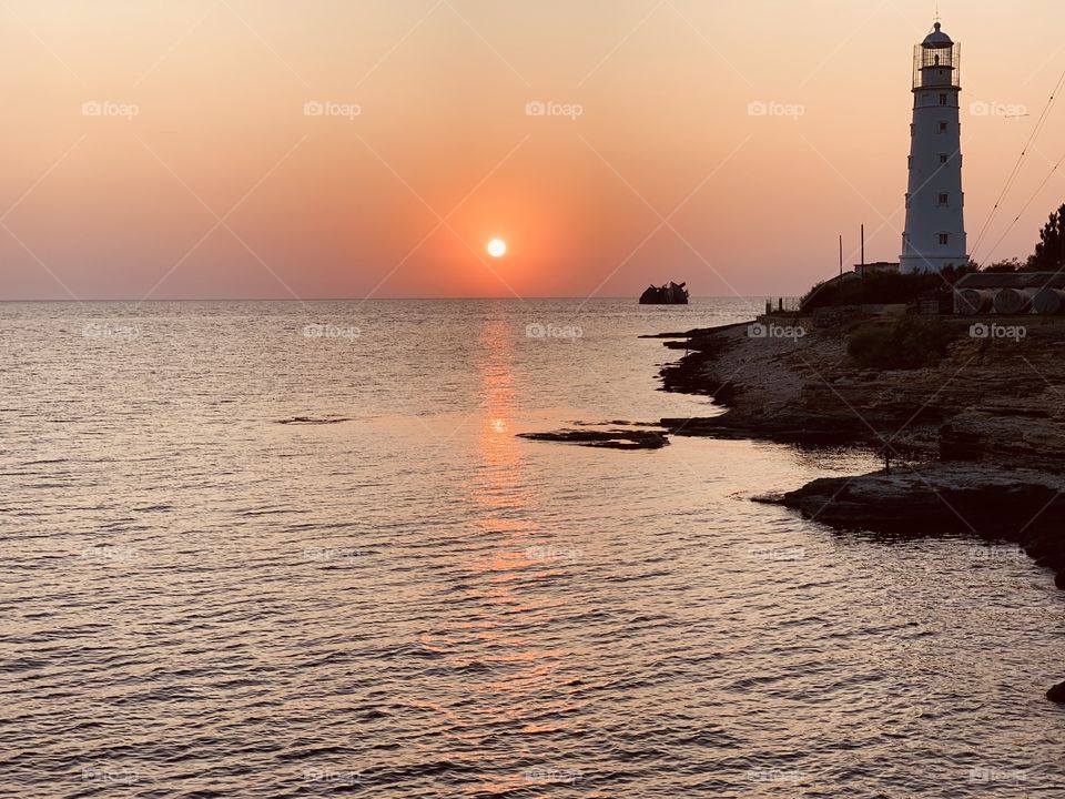 Summer evening at Cape Tarkhankut. Lighthouse at sunset.