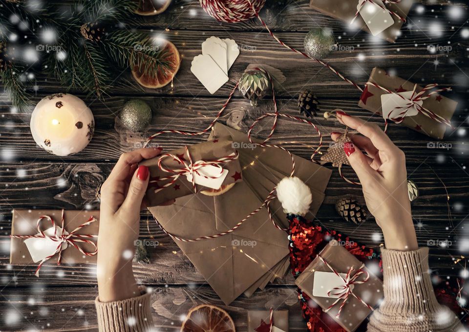 festive composition New Year on a wooden background hand with red manicure signs craft gifts