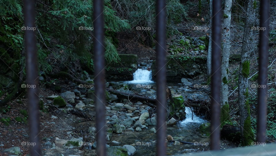 View of a stream from over a bridge