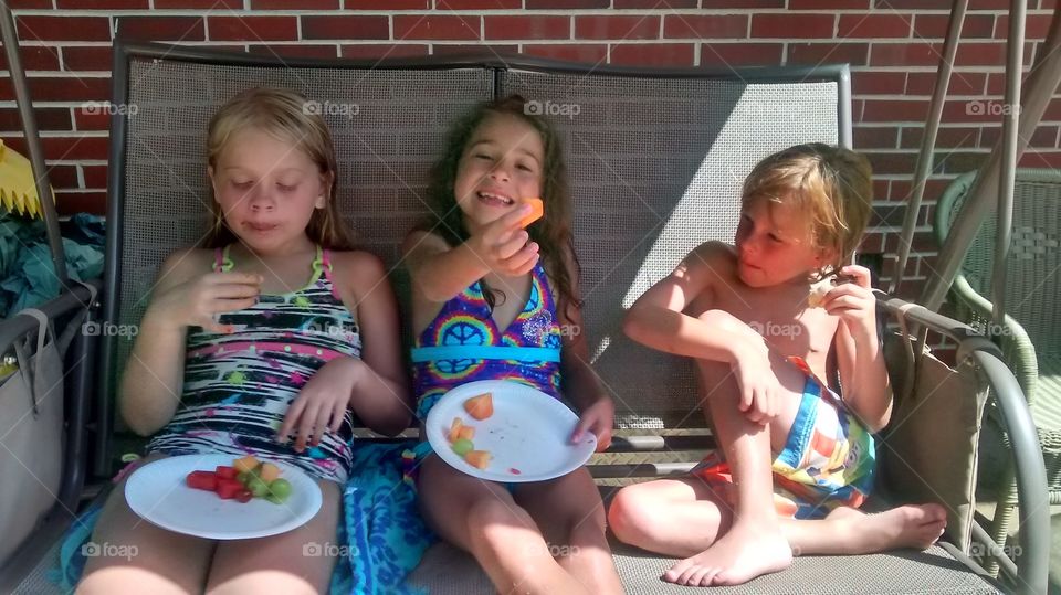 my girls and little brother eating fruit together