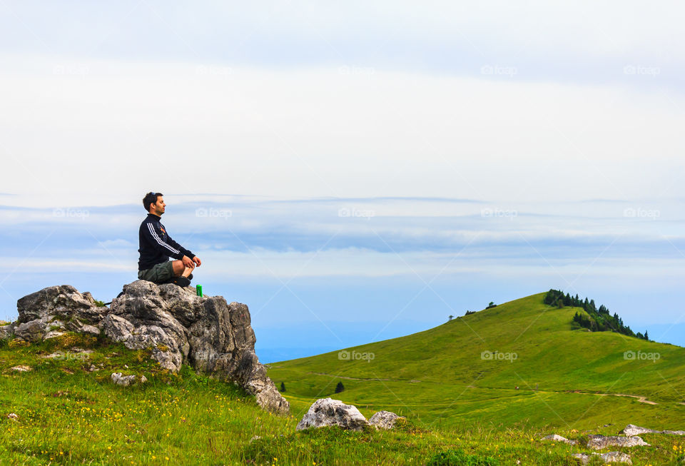 Man meditating on a rock