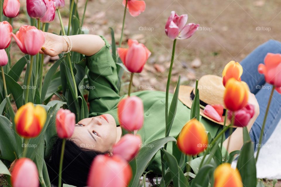 Young Asian woman relaxing in spring park