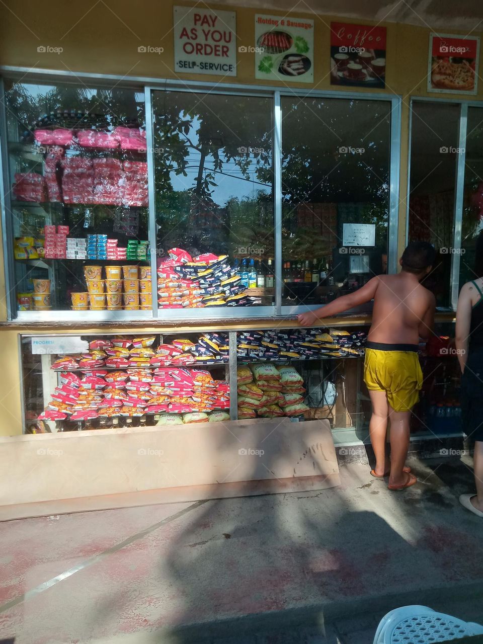 RETAIL STORE , OUTSIDE A BEACH RESORT, SELLING ASSORTED SNACKS , DISTILLED WATER, BISCUITS, CUP NOODLES, CHOCOLATES, SOFTDRINKS, CANDIES, ETC.