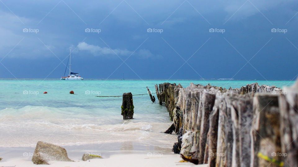 Beach in Isla Mujeres, Mexico with Cancun in the distance, sunny and an impending storm