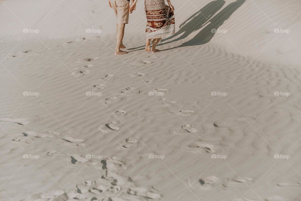 Couple in love walking in sand desert