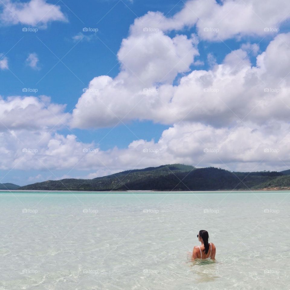 Rest and relaxation on the white sand beaches of Whitsunday Island in Australia. Bright blue skies, crystal clear water, white sand and not a soul around you.