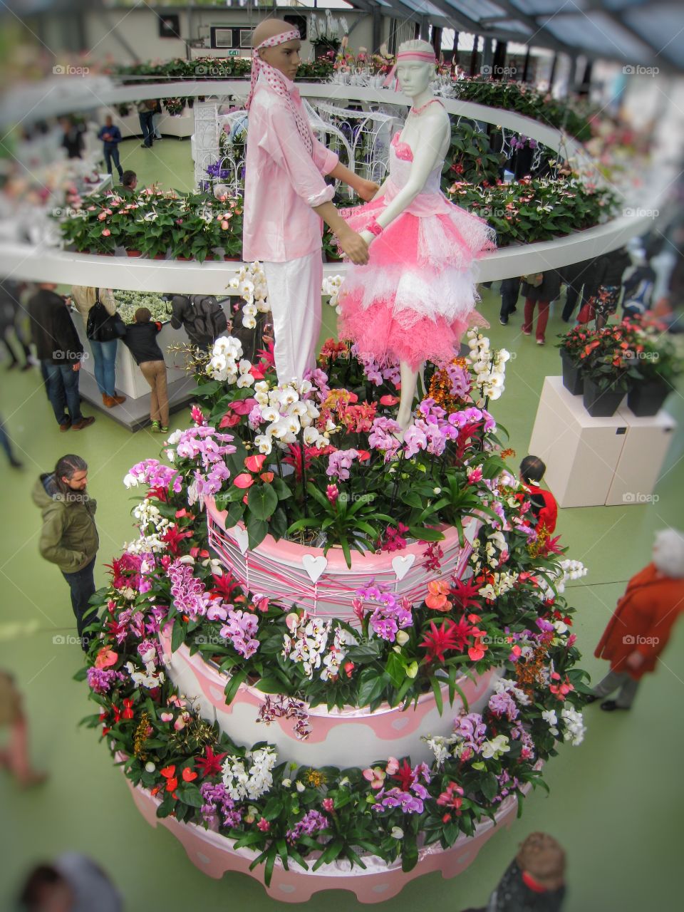 A cake from flowers and a couple on it. In Holland. Keukenhof. Exhibition of flowers 