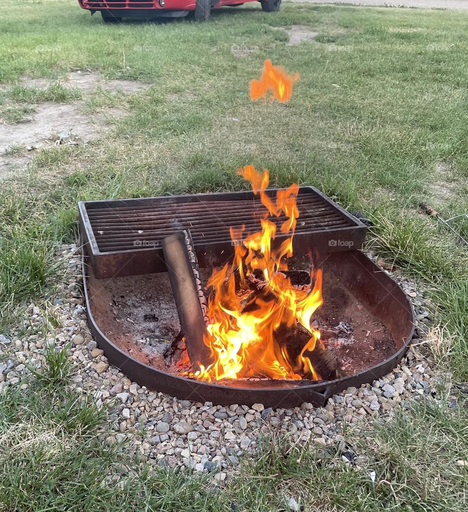 Out camping, in the evening, I made this fire with wood in the metal firepit, and took this picture and afterwards I discovered the upside down flame heart