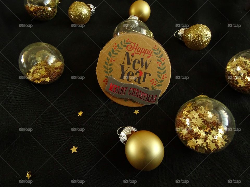 Christmas balls with golden stars and tag