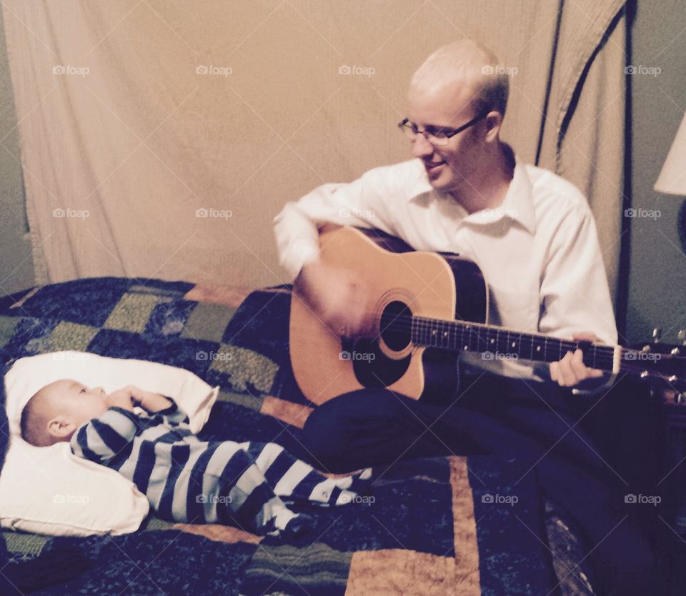 Father's Lullaby. Father sings and plays guitar for his baby son