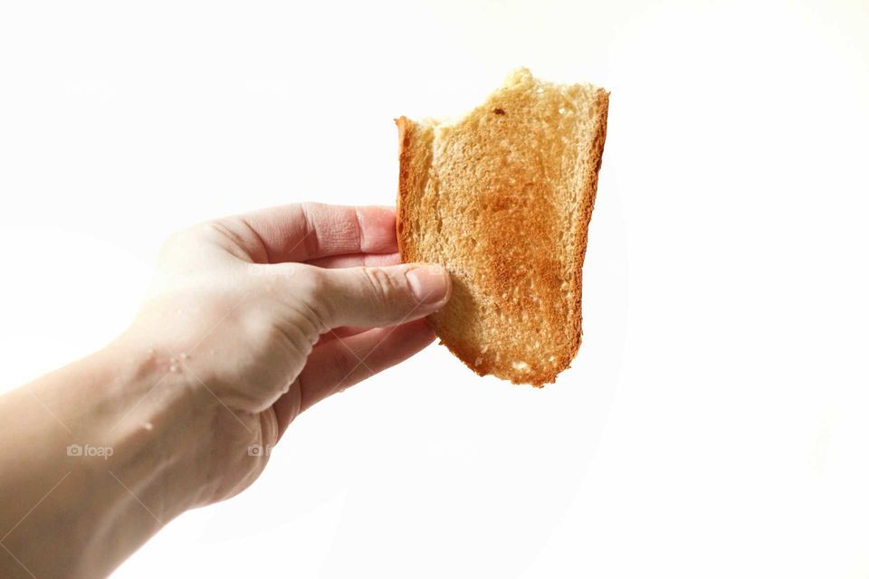 White bread fried toast in the hand