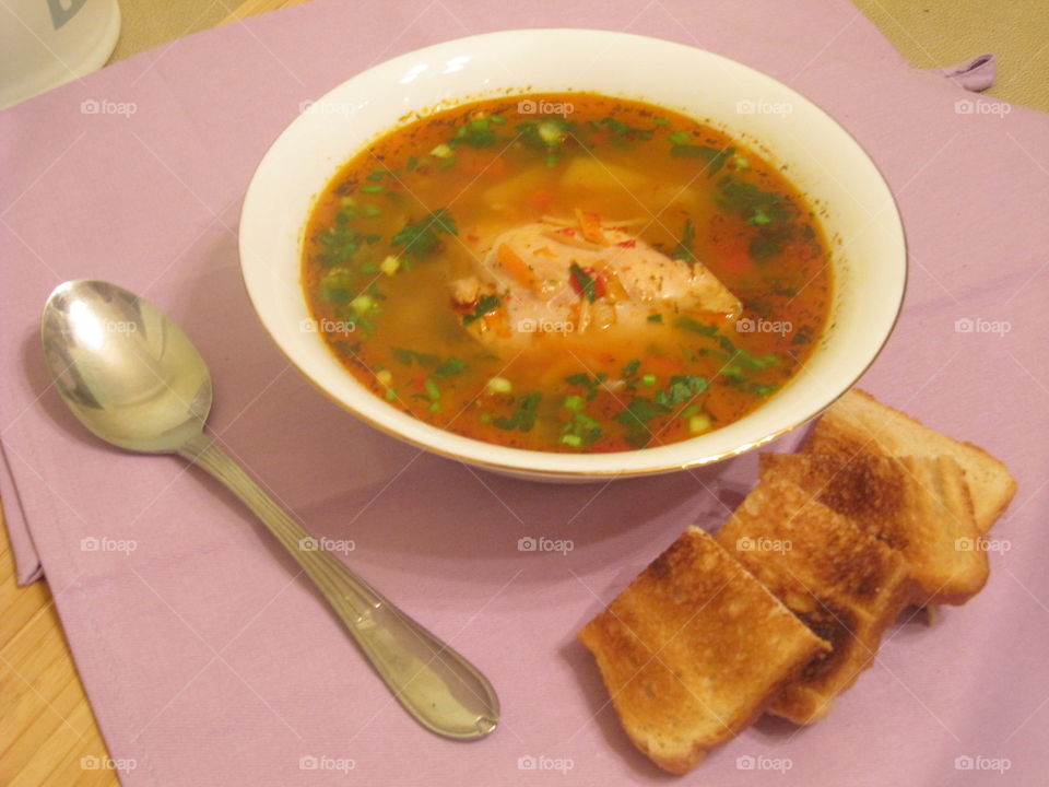 Chicken soup with parsley and toast bread