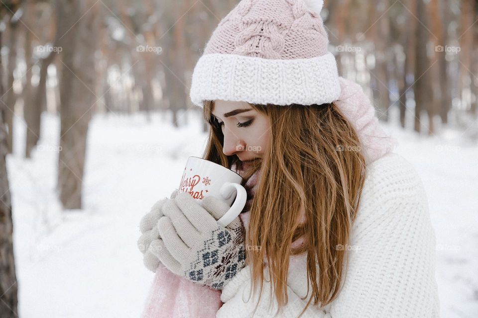 Girl in winter forest want to drink hot tea