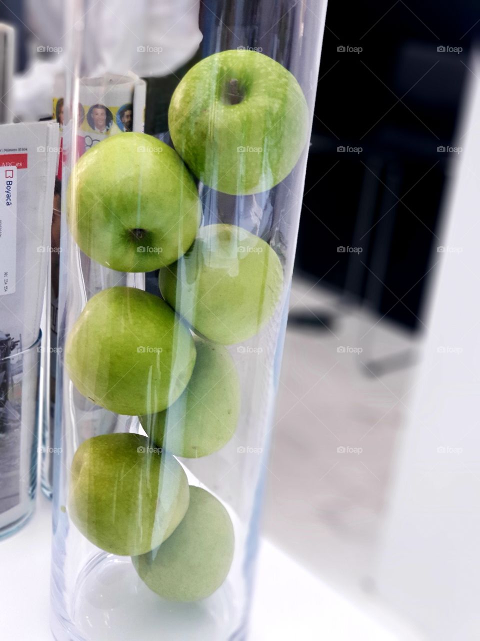 Apples in a glass tube