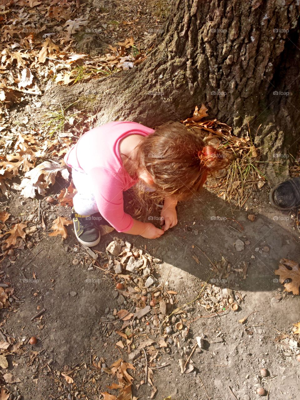 Girl playing near the tree