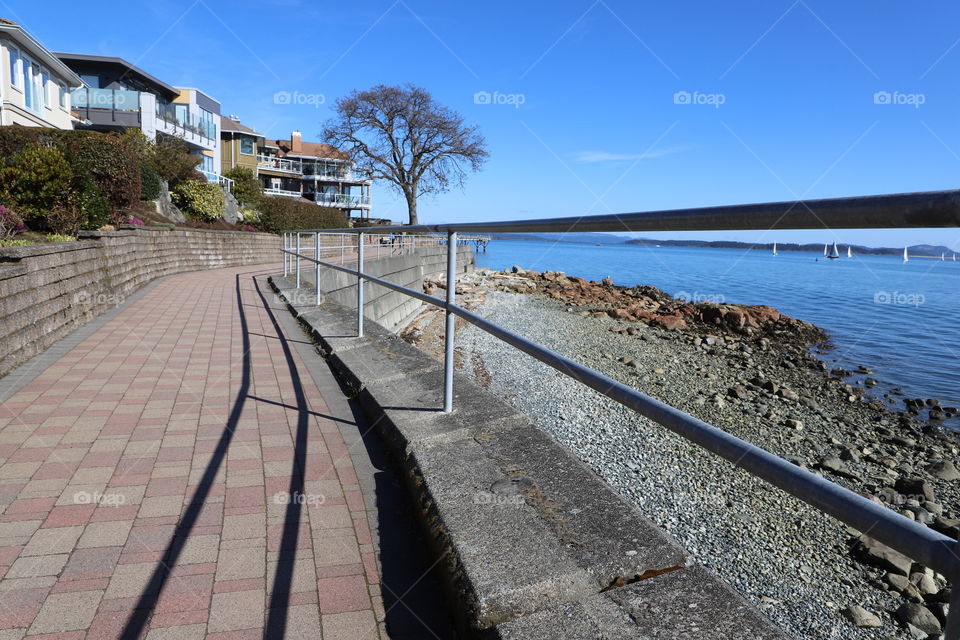 Shadow of iron fence on the path 