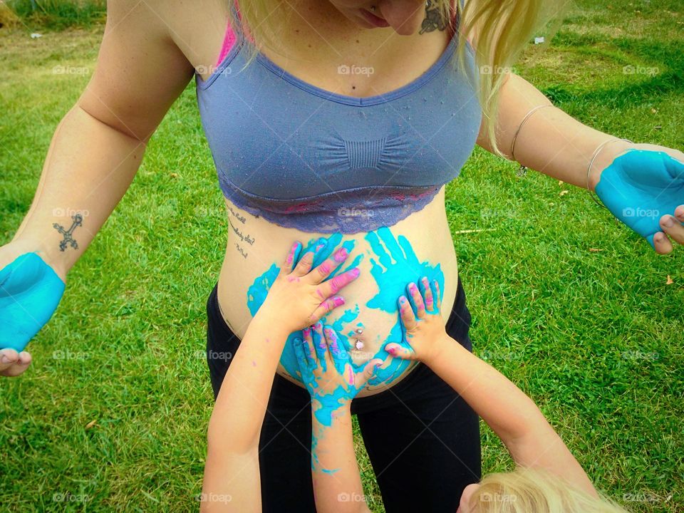 A mothers love. Our twin daughters touching mom's belly when they found out they're having a baby brother!