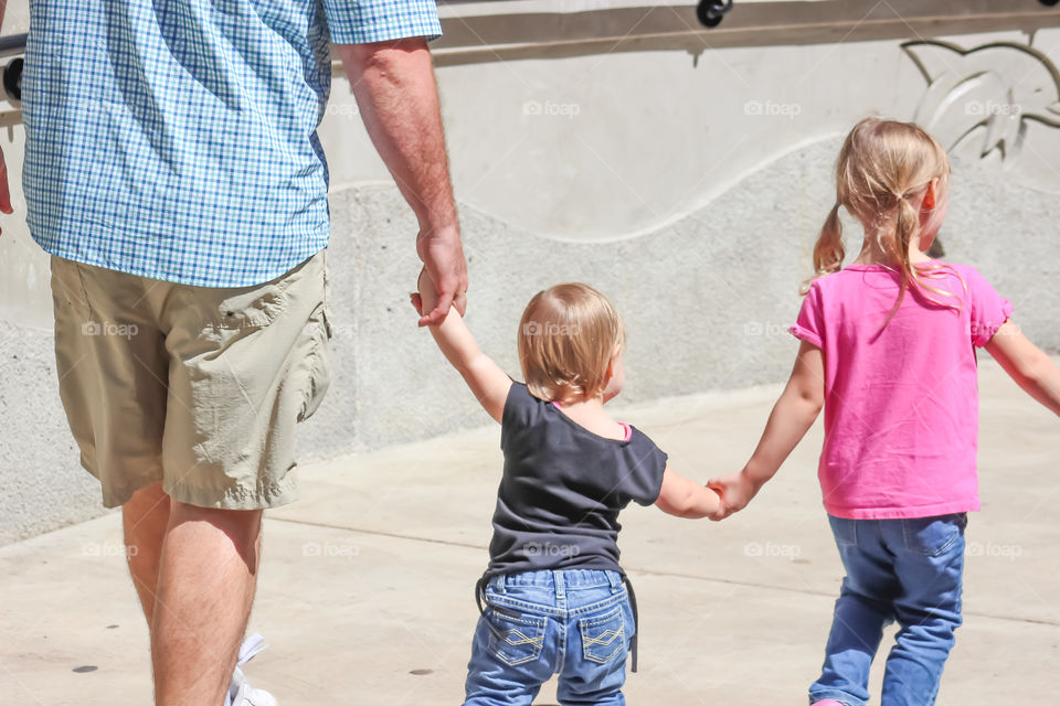 Daddy and his girls holding hands