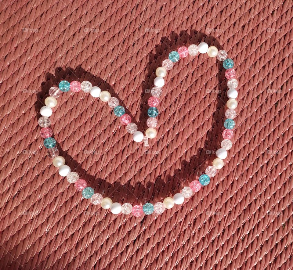 sewed beads arranged in heart shape