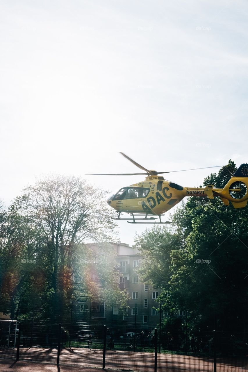 Yellow Helicopter Lands In Town