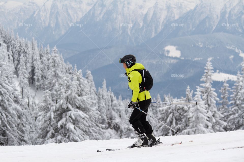 Woman skiing in peak Postavarul , Poiana Brasov, Romania 