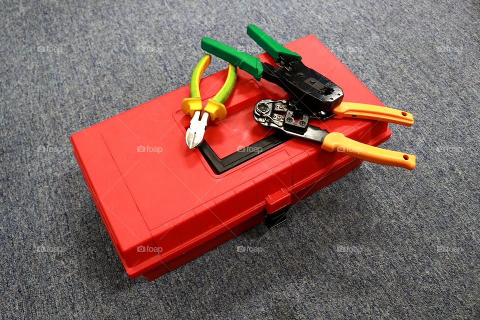 red toolbox contains various tools to work on or fix something