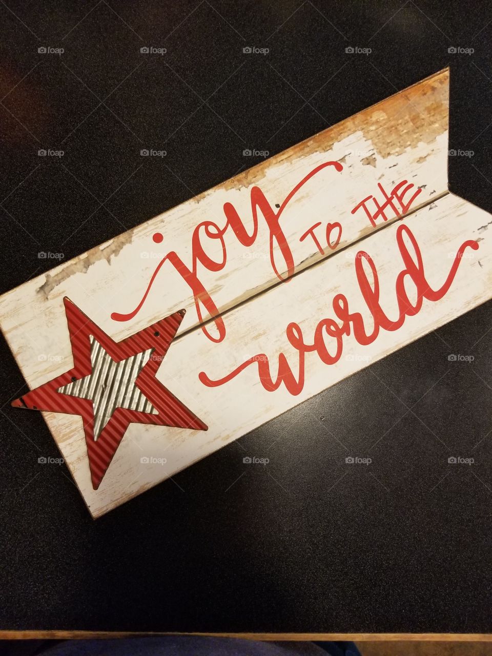 joy to the world sign accented by colored metal stars, Christmas cheer