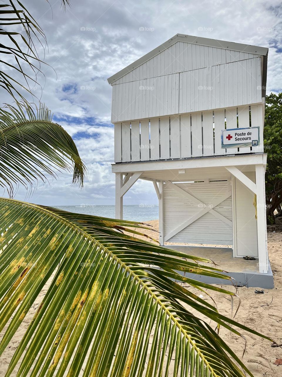 White wooden emergency cabin on a Caribbean sandy beach