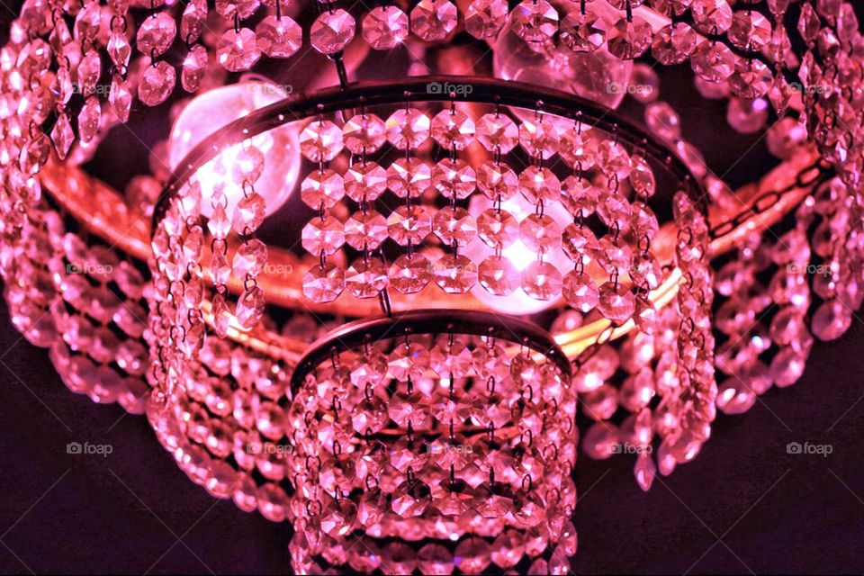 Close-up of a pink illuminated crystal chandelier