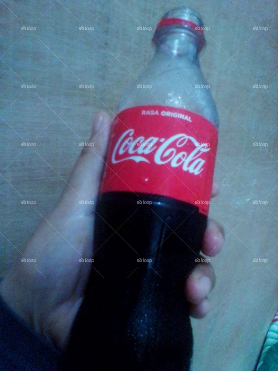 One bottle of cold Coca-cola in your hand