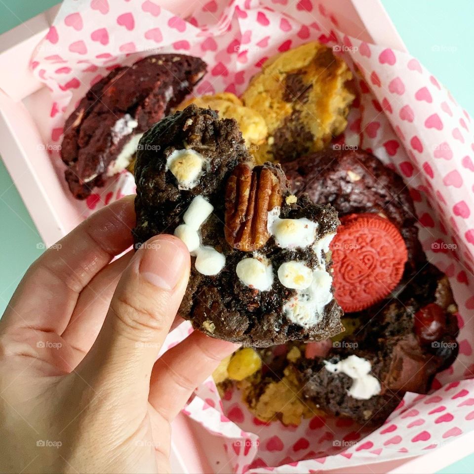 Freshly baked Gooey Easter cookies in chocolate in big chunk with hot tea for afternoon snack 