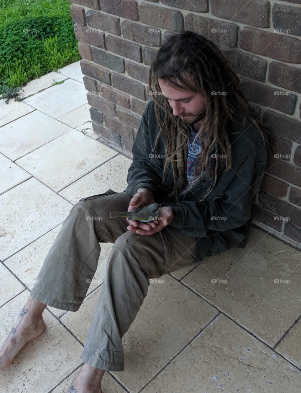 Gently holding a stunned bird. Hoping it will be alright after a rest