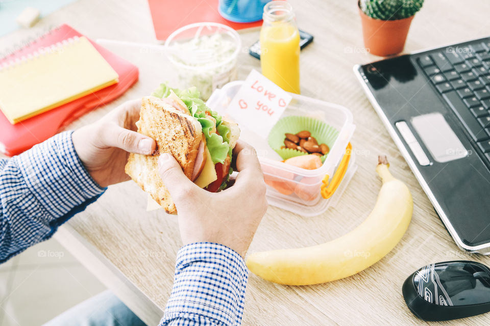 Man holding his sandwich. Lunch time