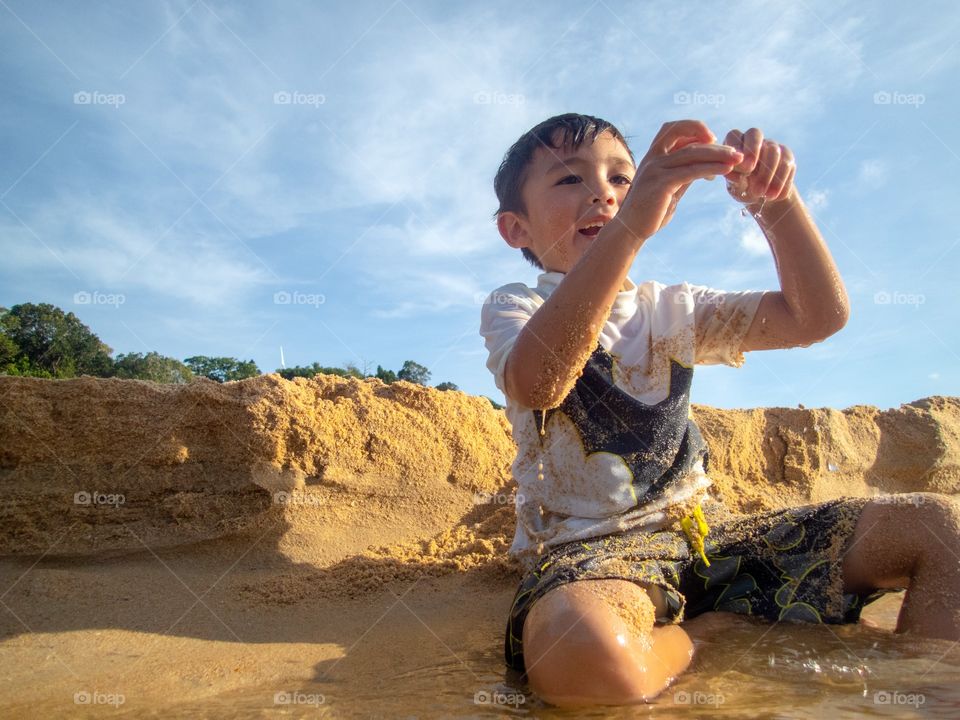 Boy playing in the sand