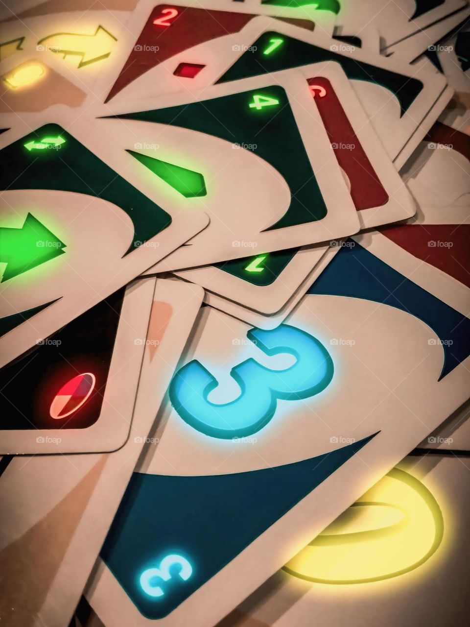 Close-up of a number of scattered cards, with various colors and numbers. Colorful cards lying randomly