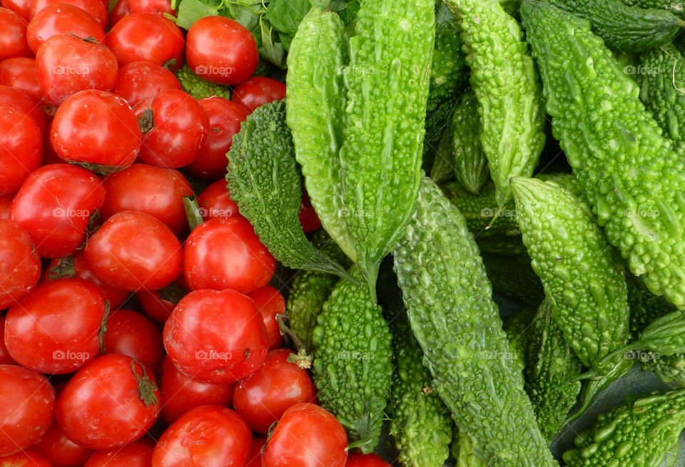Elevated view of fresh tomatoes and bitter gourd