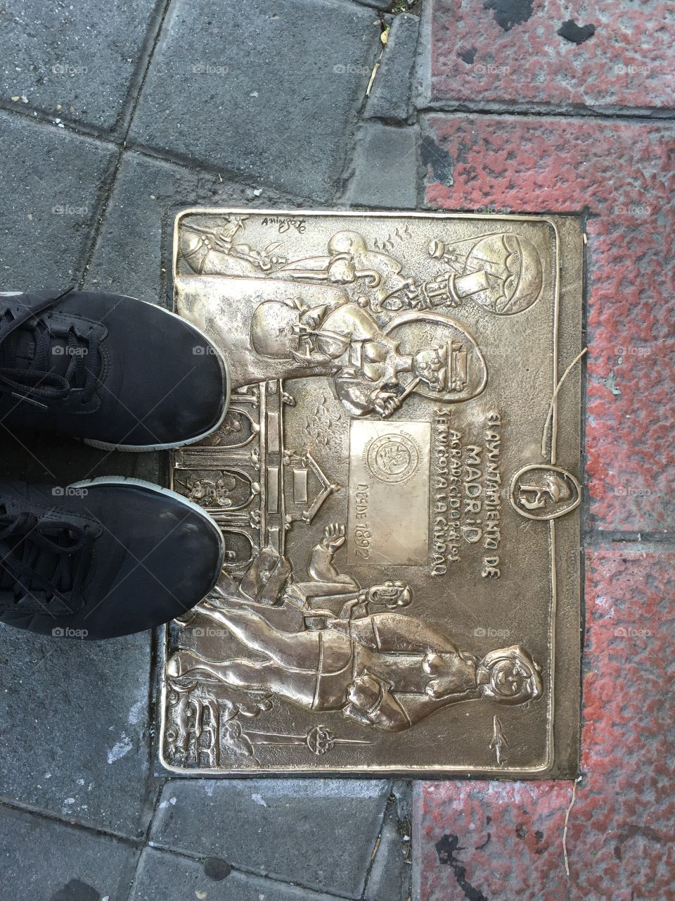 Shoes standing on a sign 