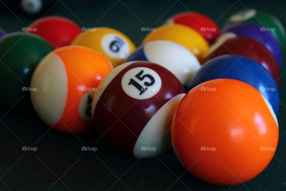 Close-up of pool balls on top of a pool table.