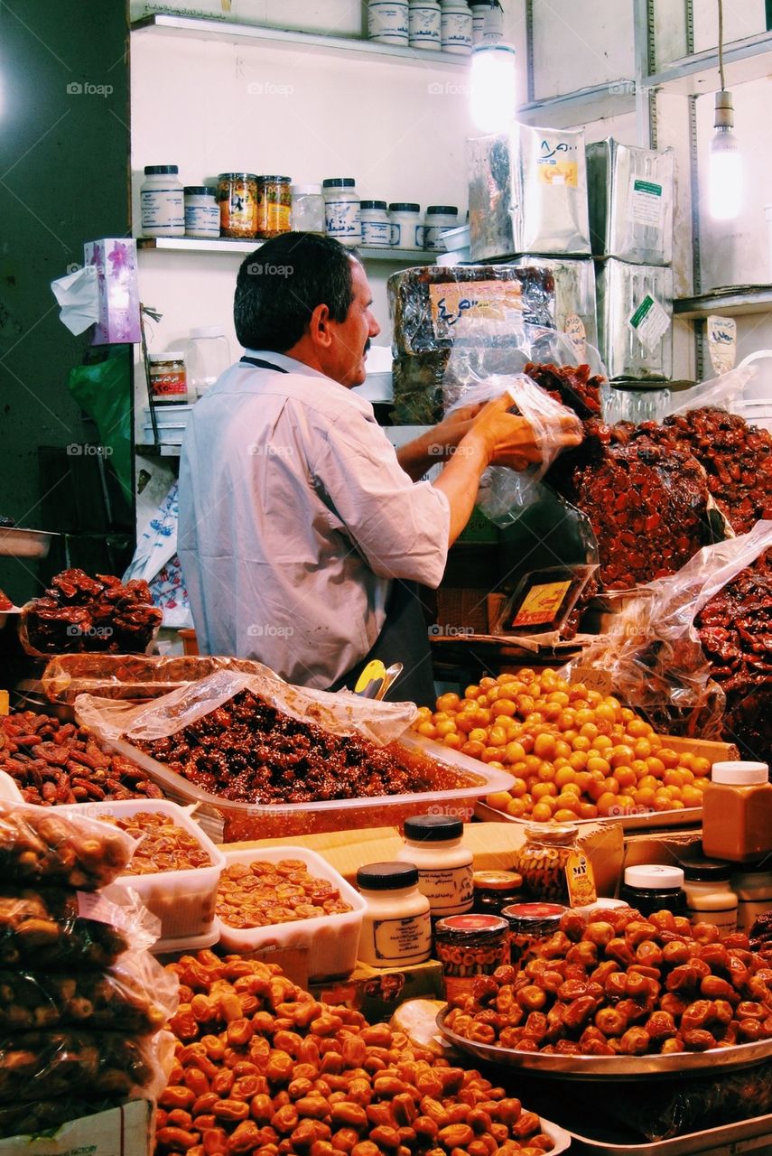 Man selling Arabic sweets and foods at the market