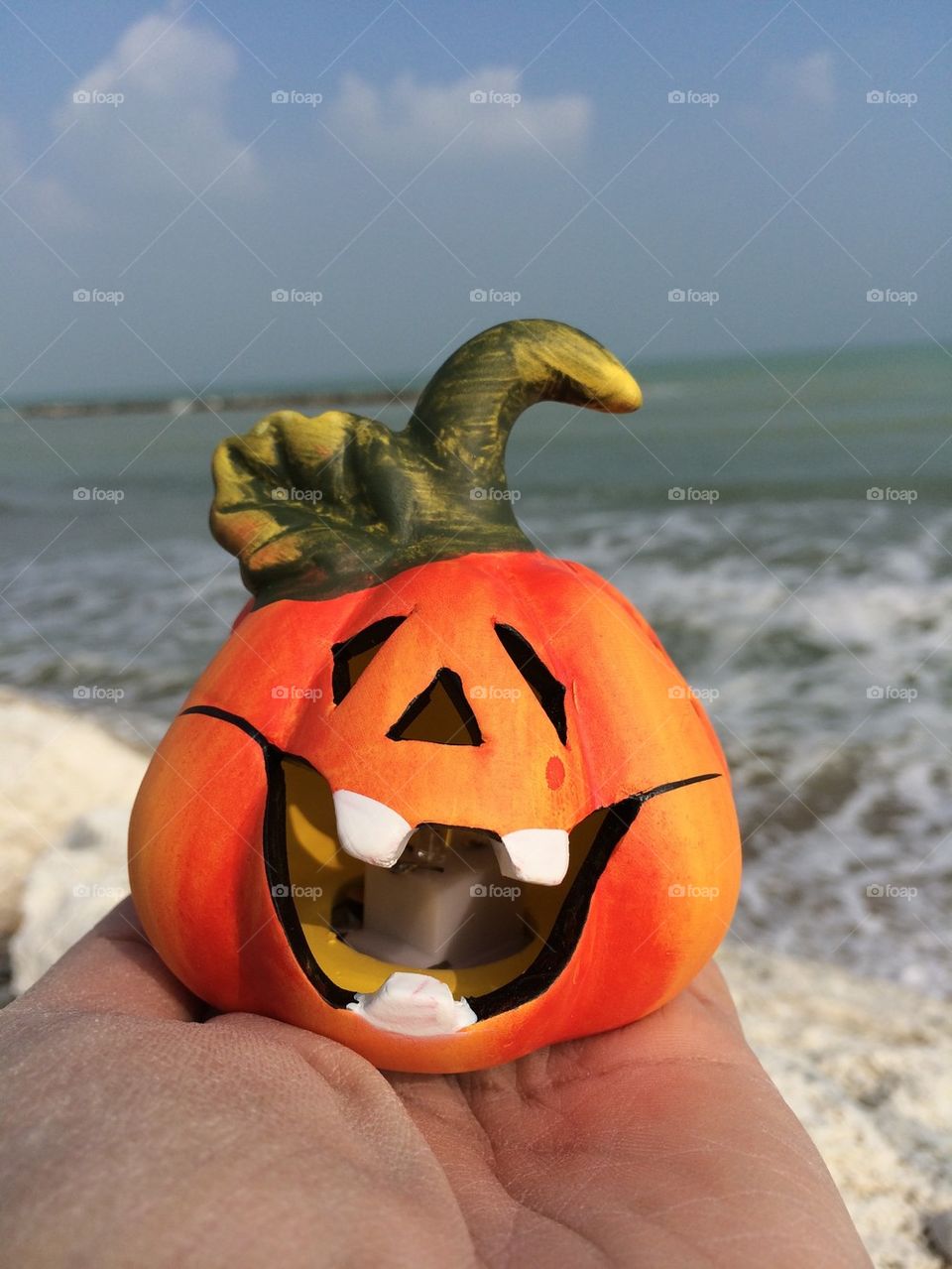 Halloween pumpkin,ornamental object on a hand